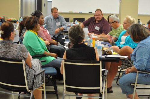 Photograph of one of three break-out groups speak about their experiences and search for best practices.