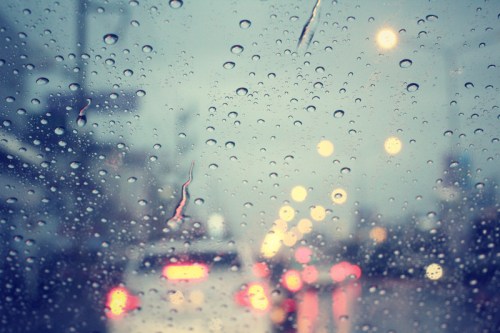 Photograph of cars through a wet windshield to illustrate Revera's decison to claw back mileage rates from their PSWs.