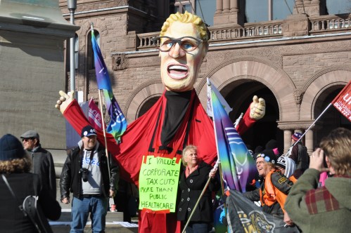 Photograph of large Kathleen Wynne puppet at the November rally against privatization of hospital services.